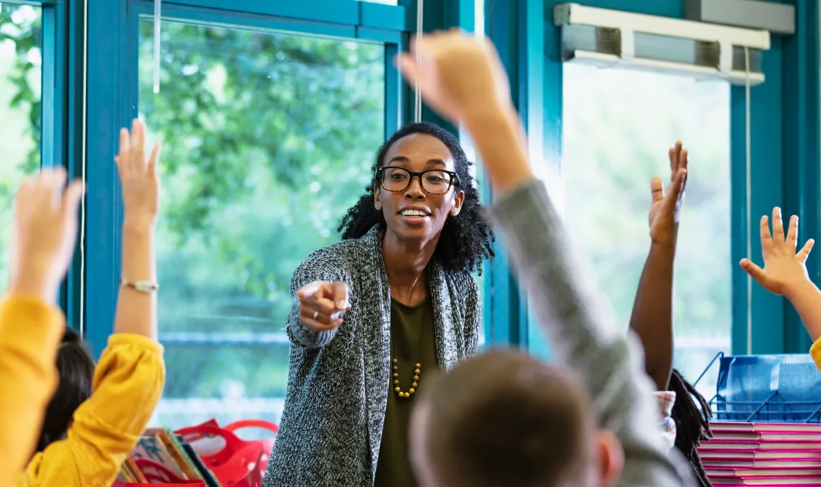 Educator facilitating discussion with students in a supportive learning environment